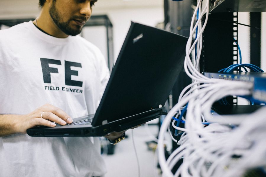 Engineer managing IT systems in a server room