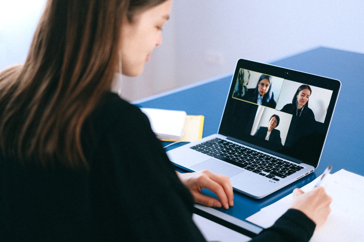 Employee joining a video conference call on a laptop
