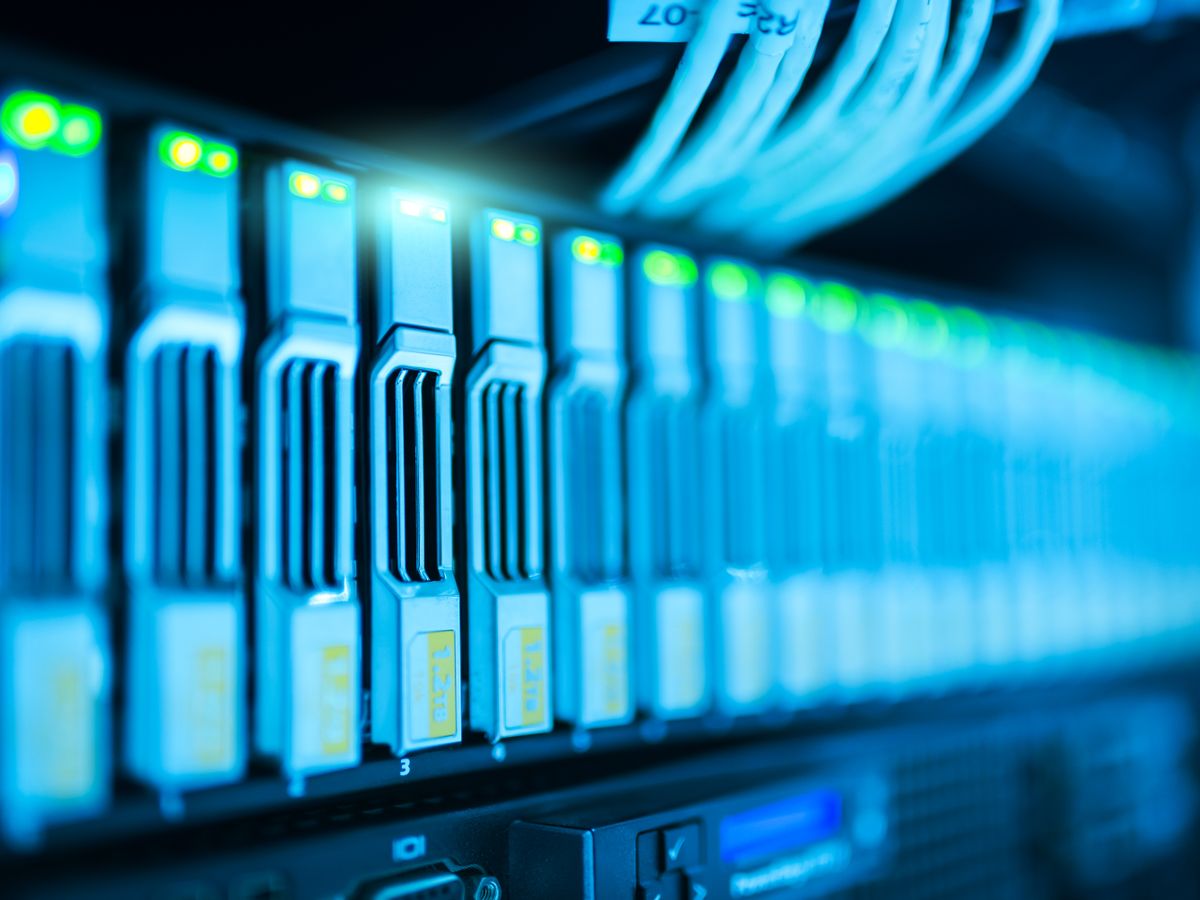 Server rack hardware glowing blue in a data center
